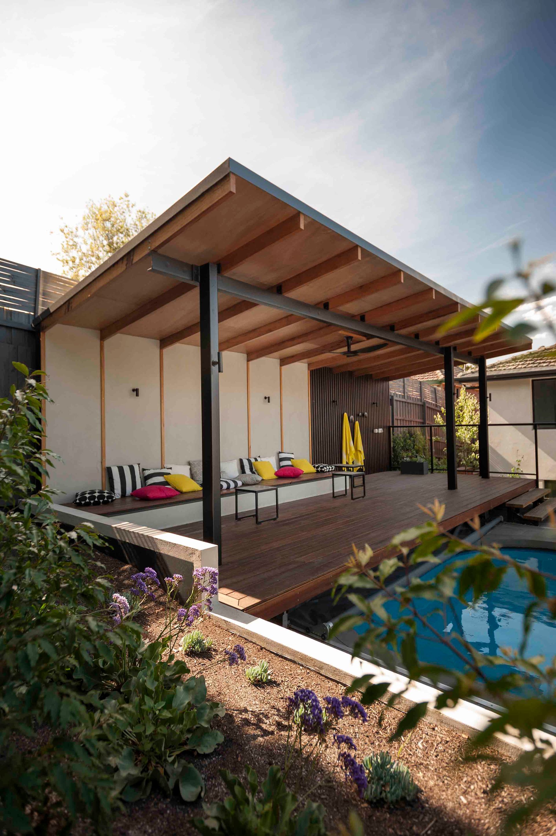 There is a swimming pool in the backyard of a house.