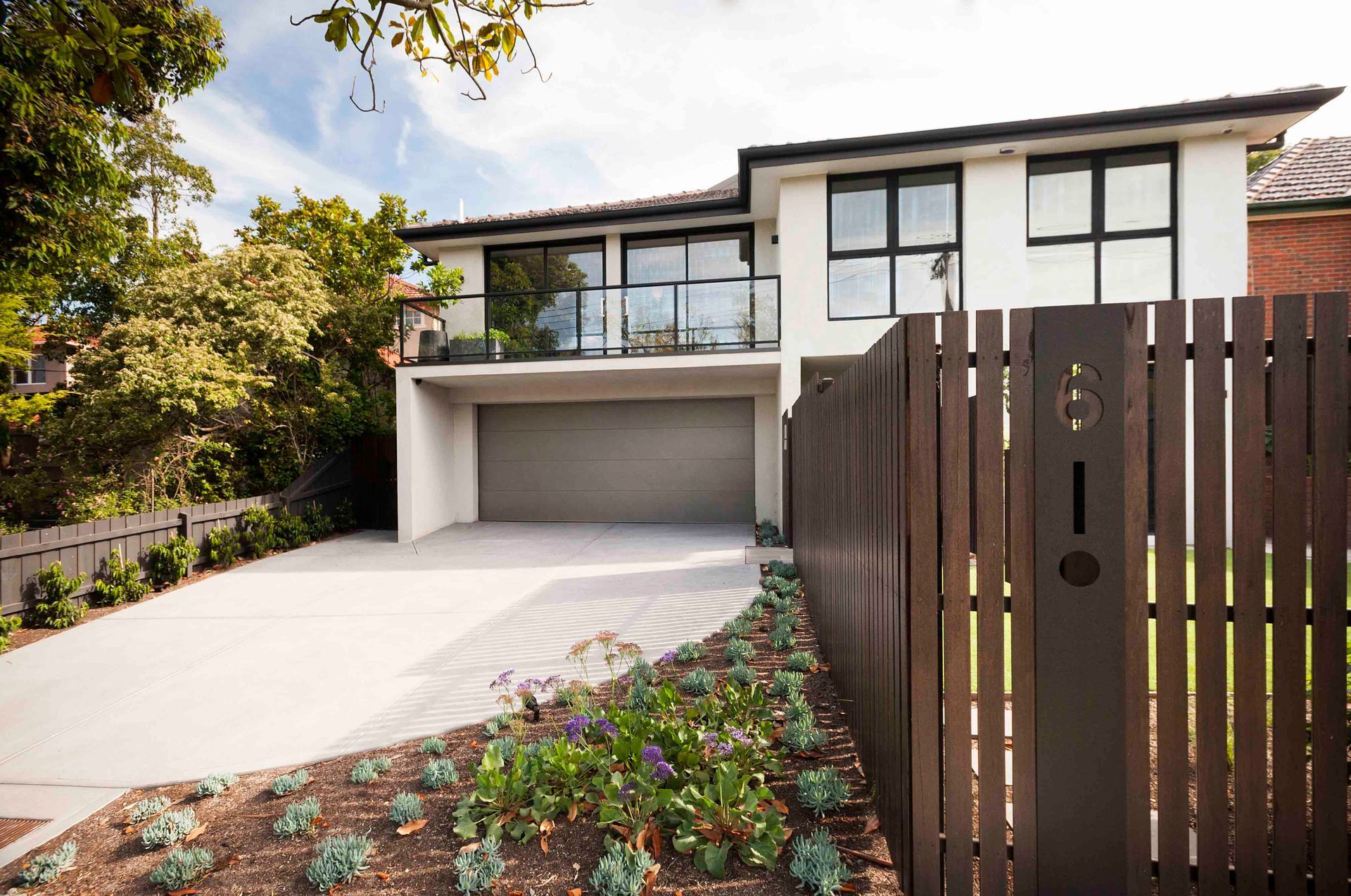 A house with a wooden fence in front of it