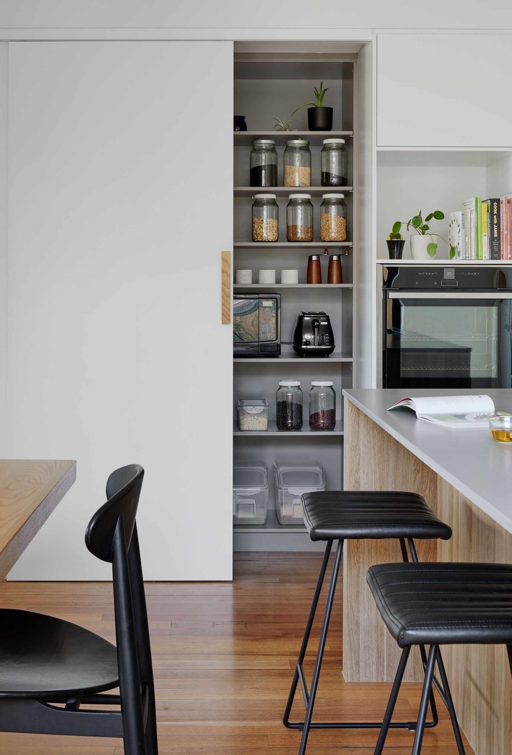 A kitchen with a table and chairs and a pantry