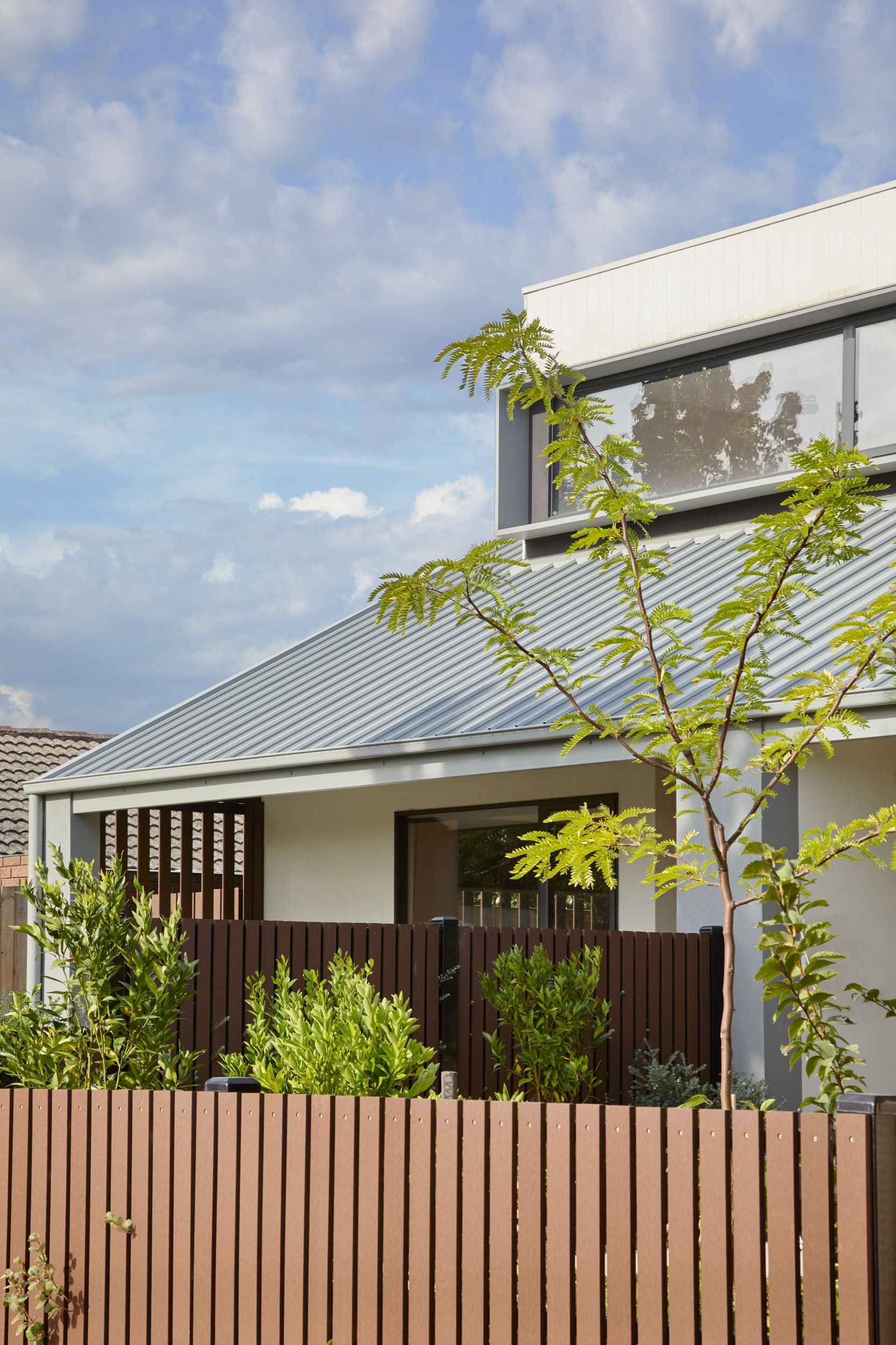 A house with a wooden fence in front of it