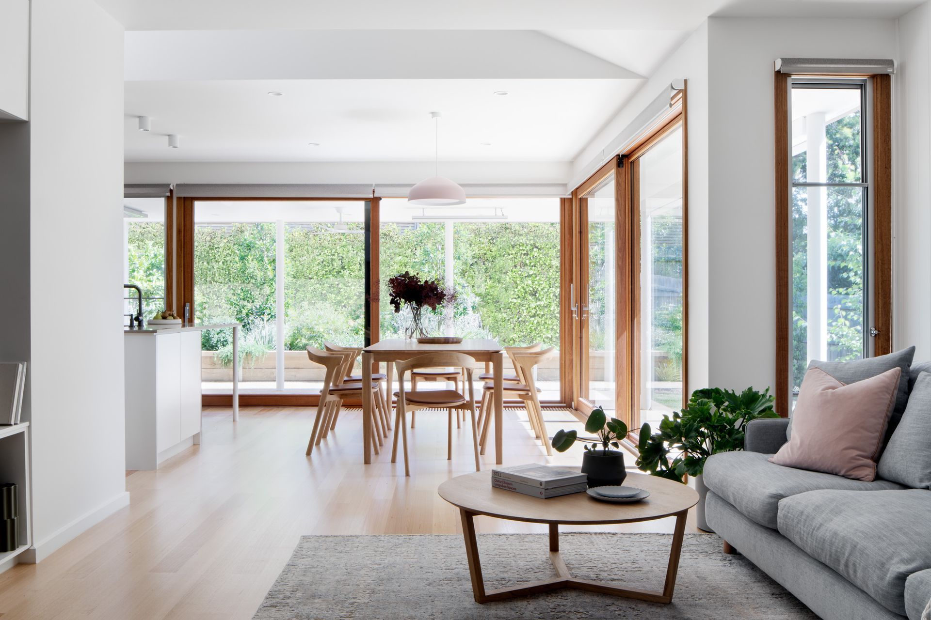 A living room with a couch , table and chairs
