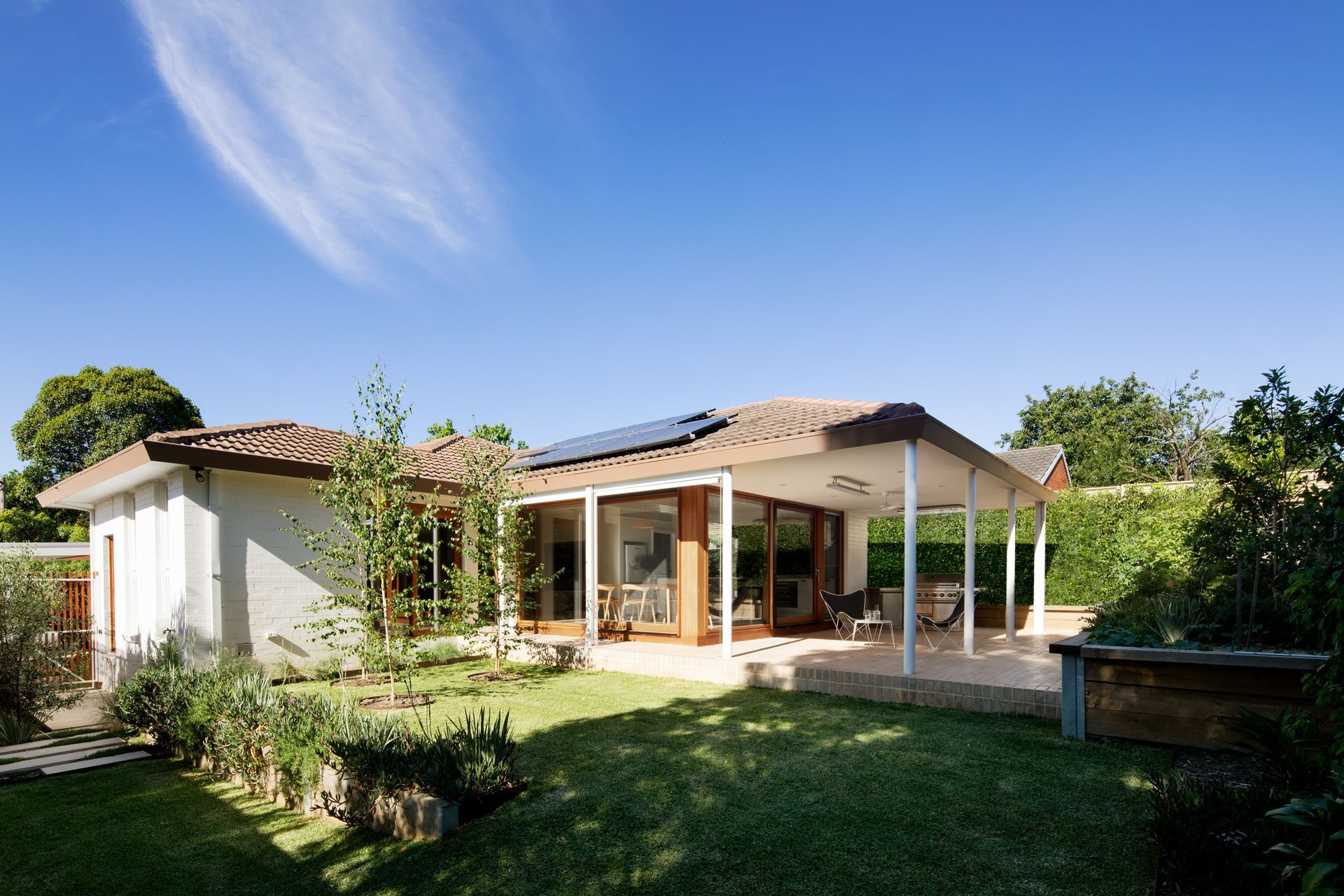 A house with a large lawn in front of it