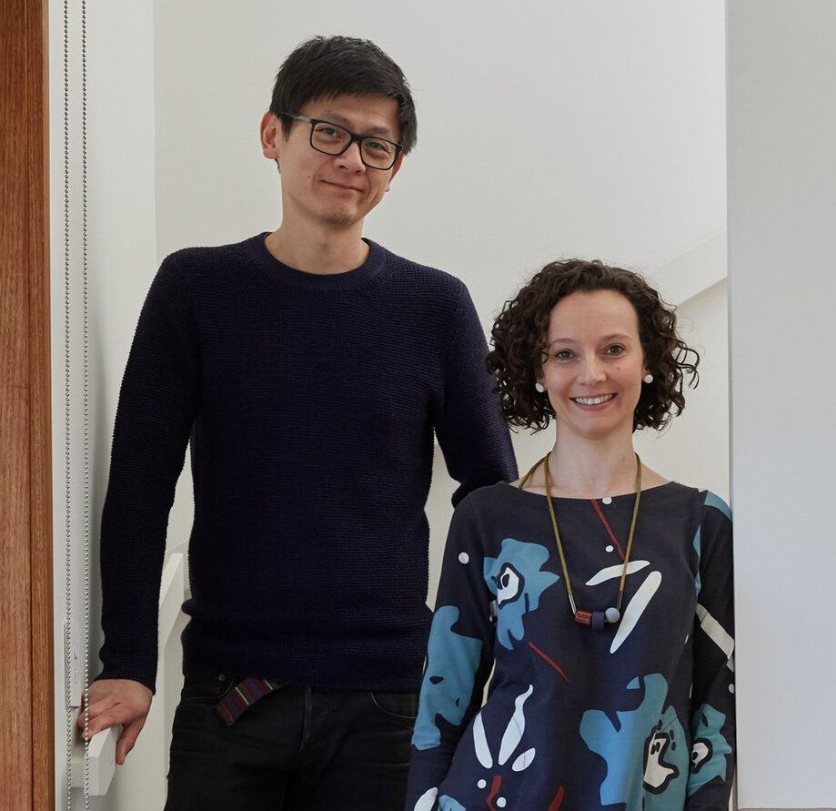 A man and a woman are standing next to each other and smiling