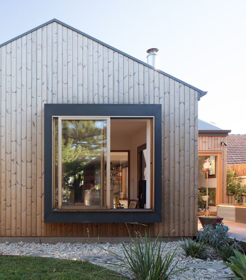 A house with a large window on the side of it