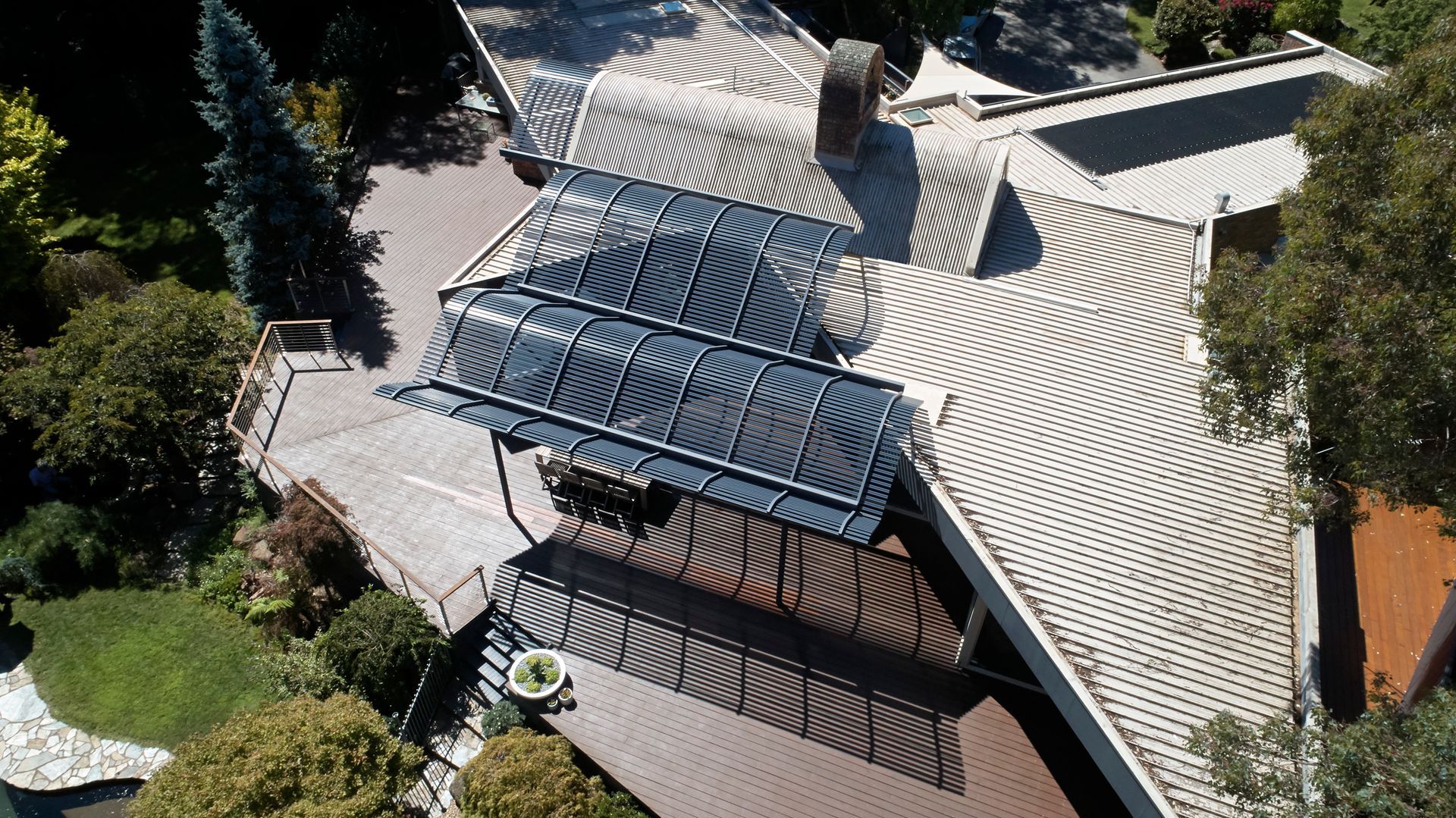 An aerial view of a house with solar panels on the roof
