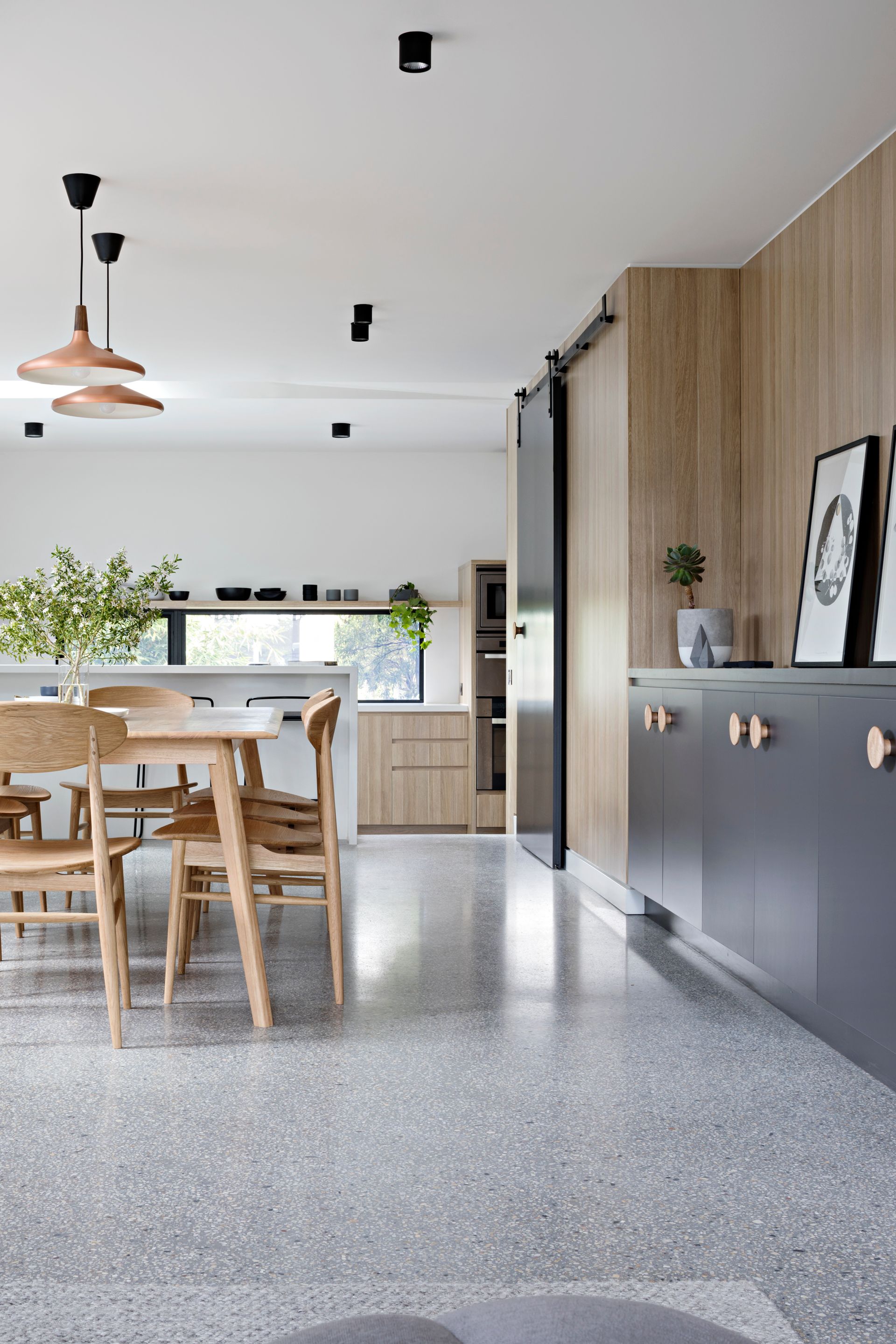 A kitchen with a dining table and chairs in it.