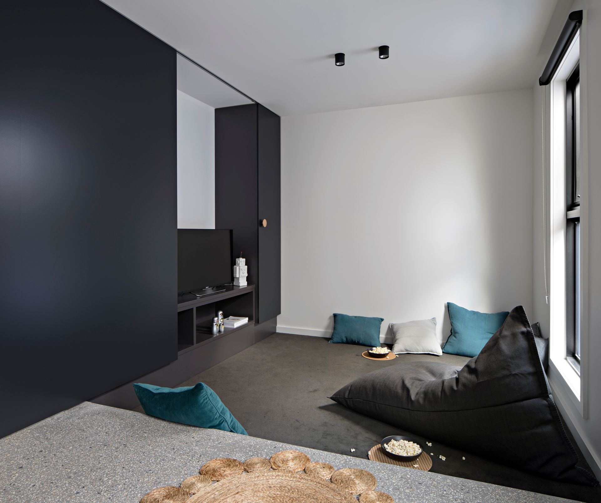 A living room with a bean bag chair and pillows