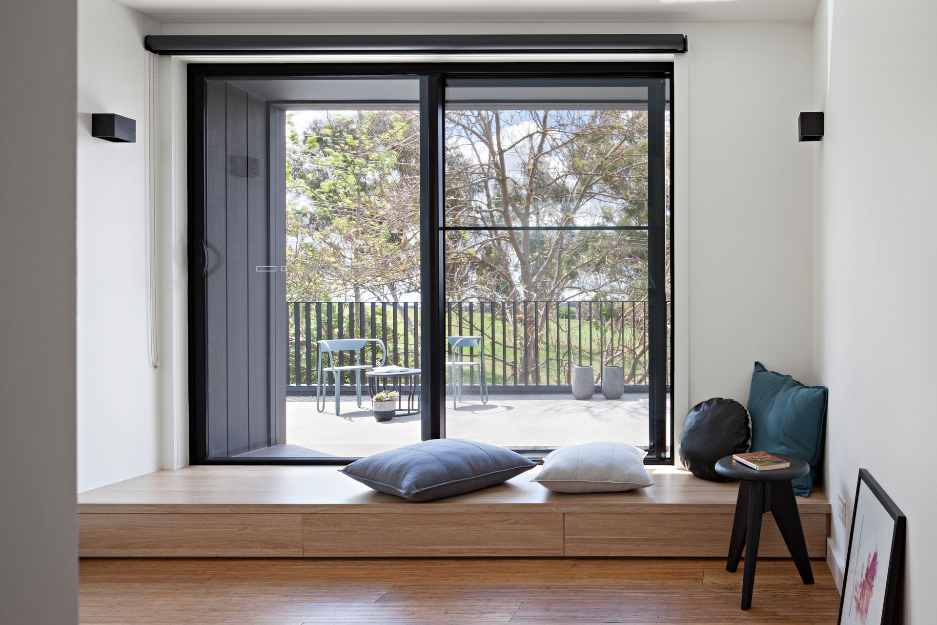 A living room with a sliding glass door leading to a balcony.