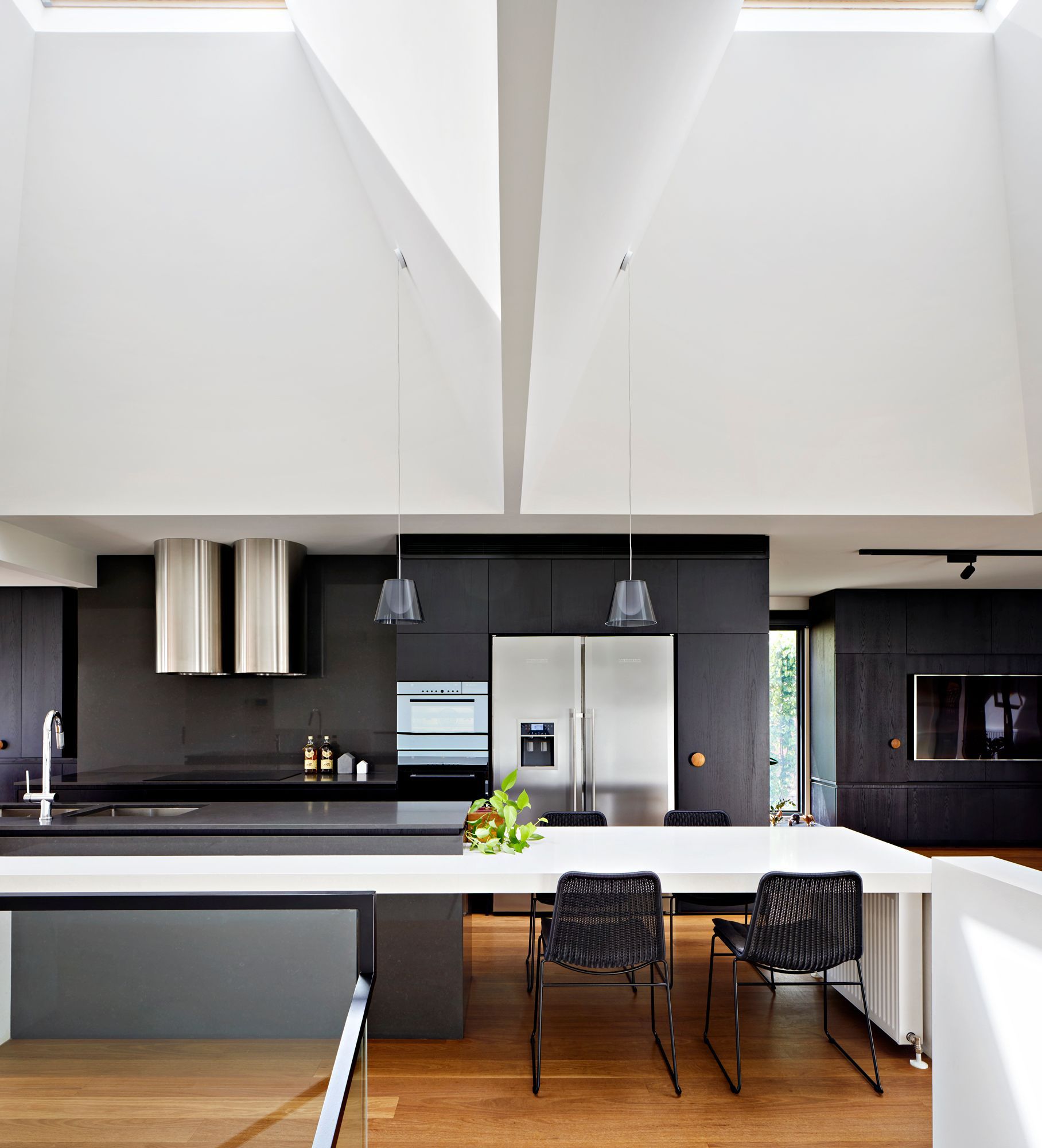 A kitchen with black cabinets and stainless steel appliances