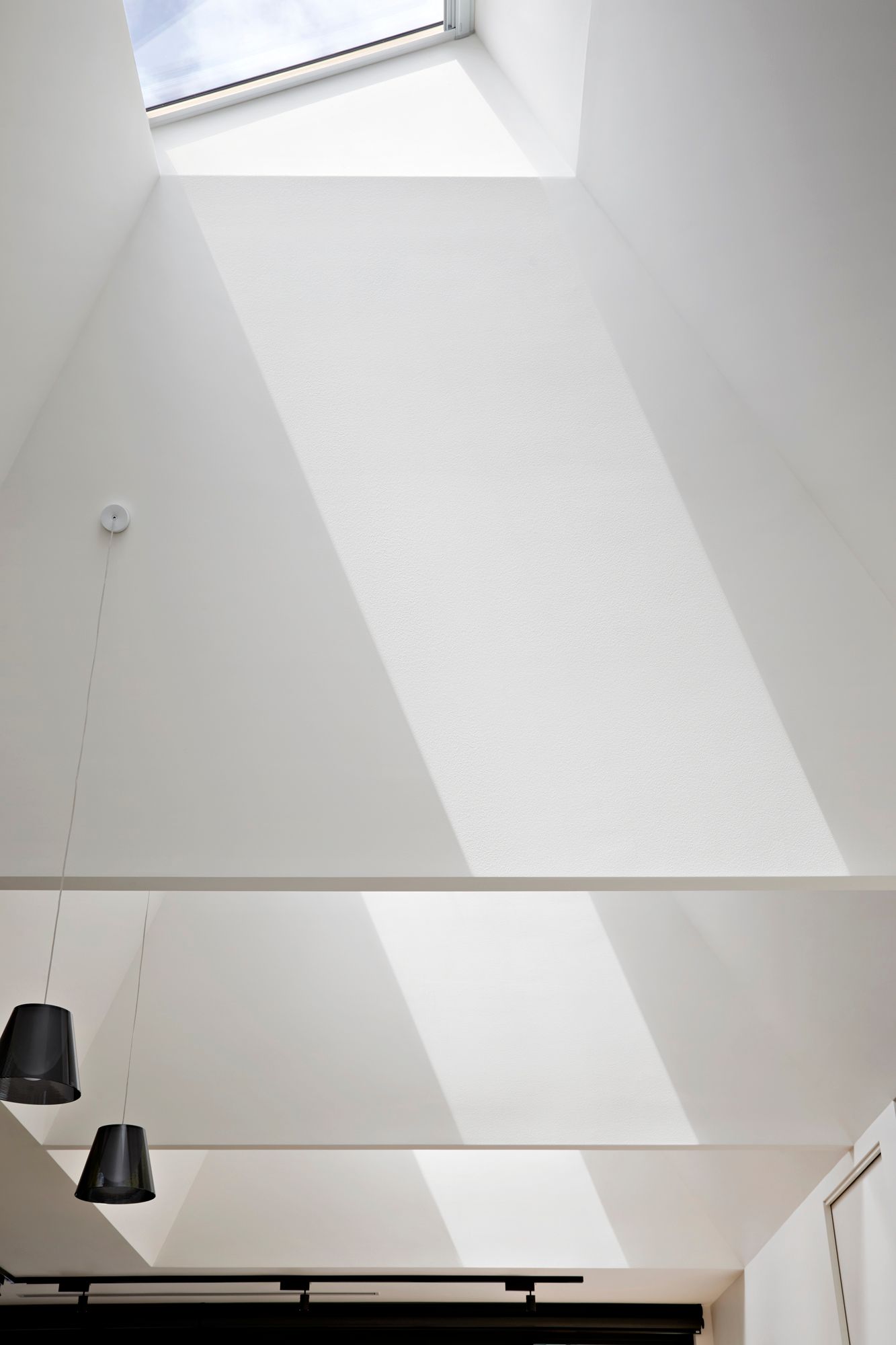 A white ceiling with a skylight in the middle of it