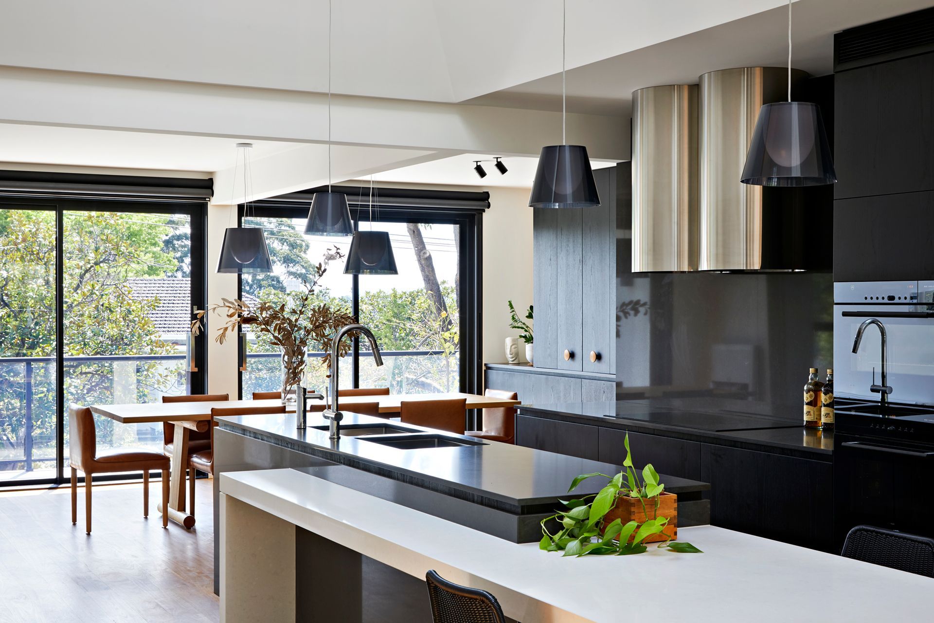 A kitchen with black cabinets and a white counter top