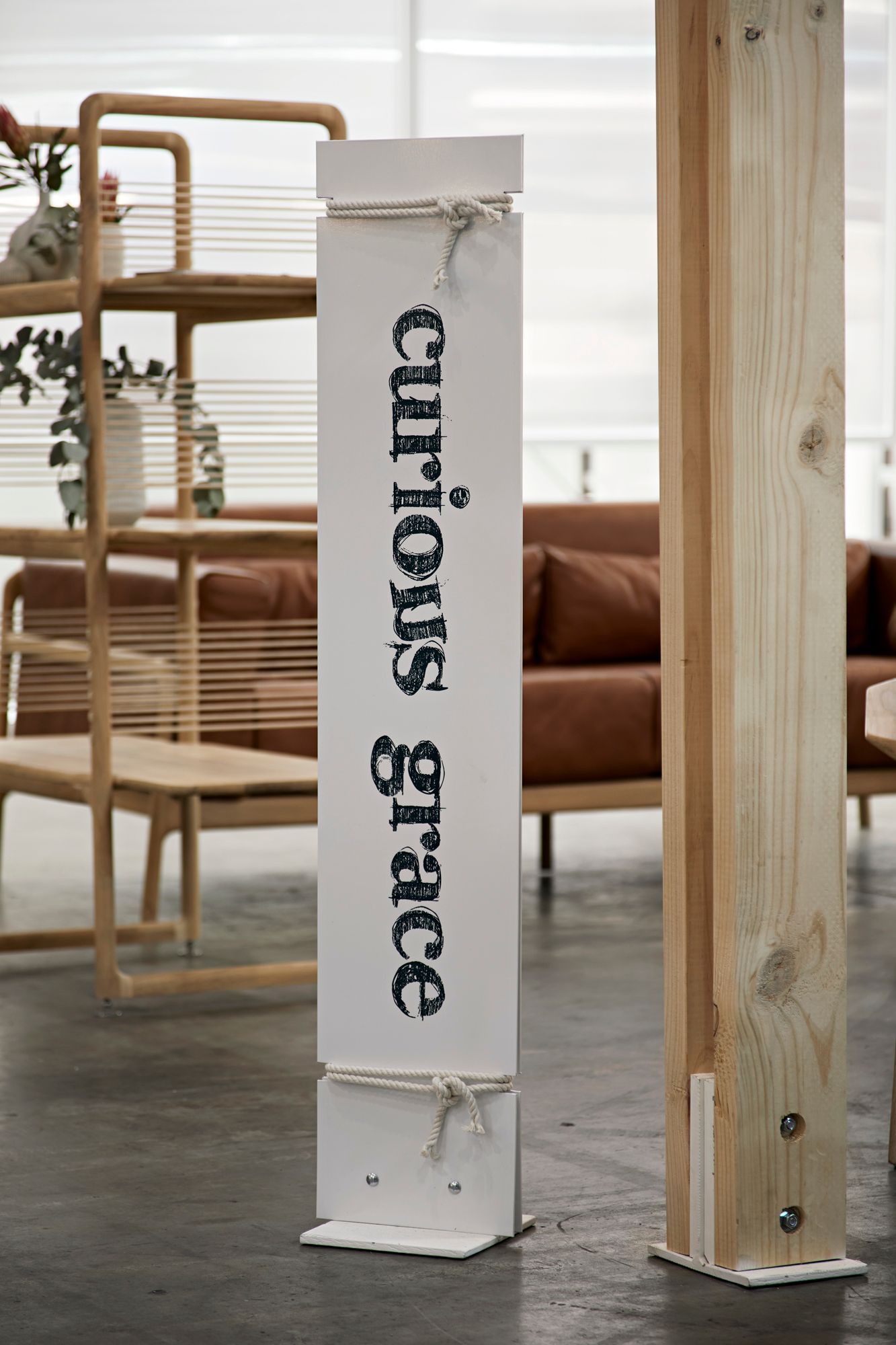 A sign that says curious grace is in a living room
