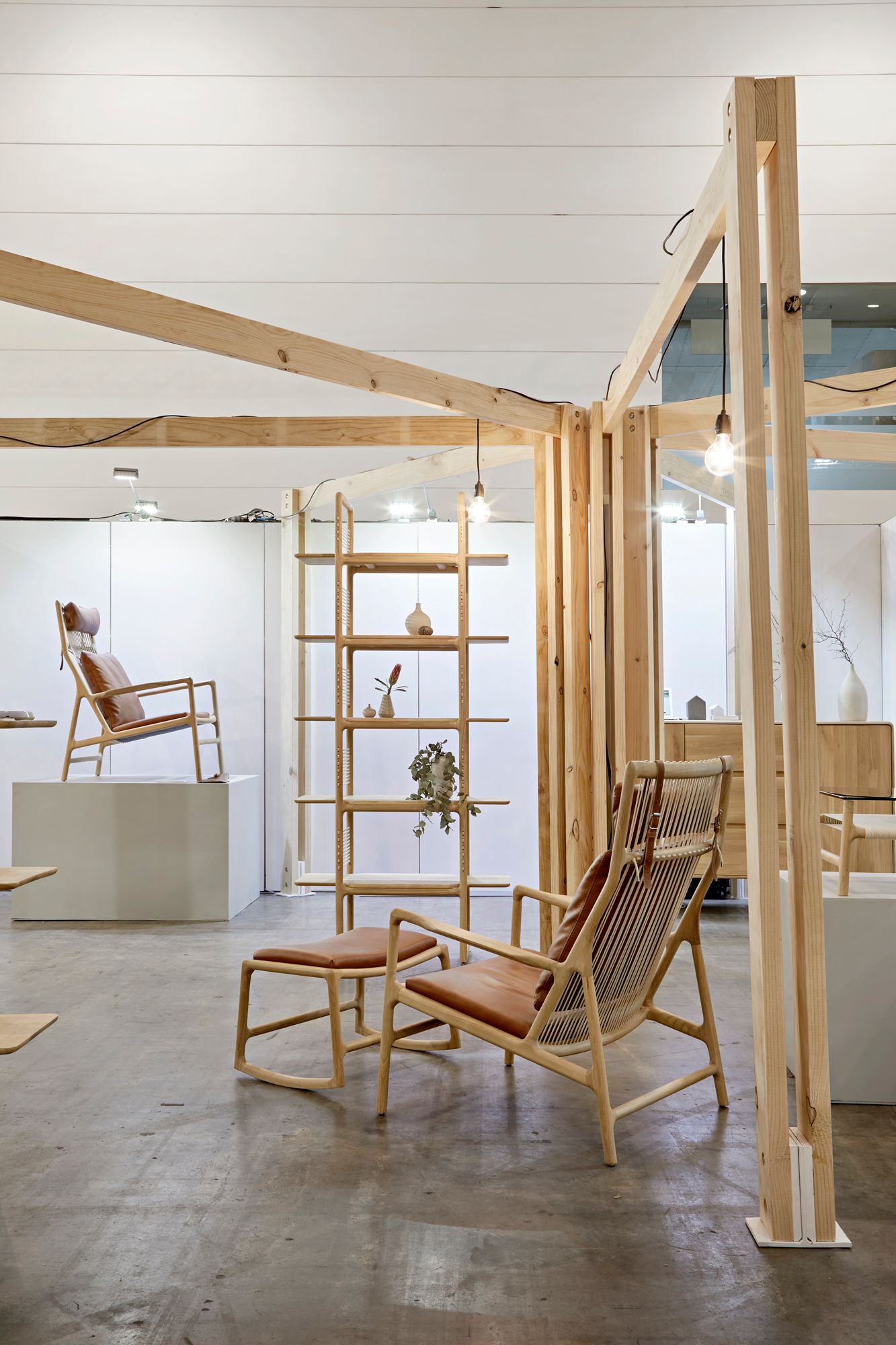 A room with chairs and a shelf in it