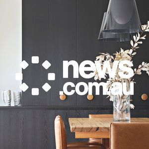 A dining room with a table and chairs and the news.com.au logo