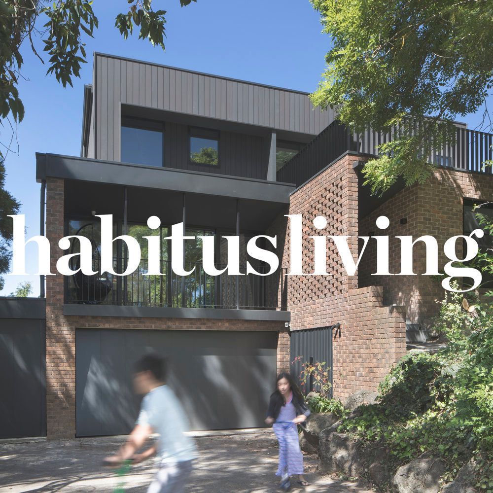 A man and woman are walking in front of a habitus living house