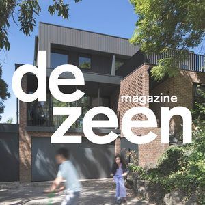 A man and a woman are walking in front of a house that says de zeen magazine