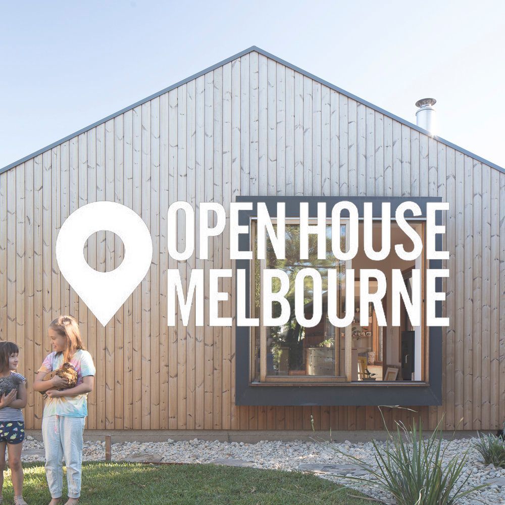 A woman and a child are standing in front of a house that says open house melbourne