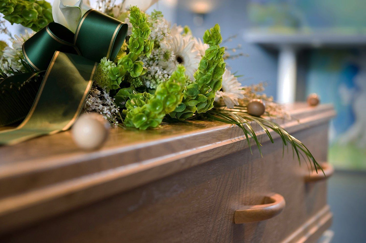 a wooden coffin with flowers on top of it .