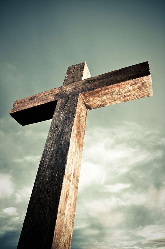 the old rugged cross against a cloudy sky