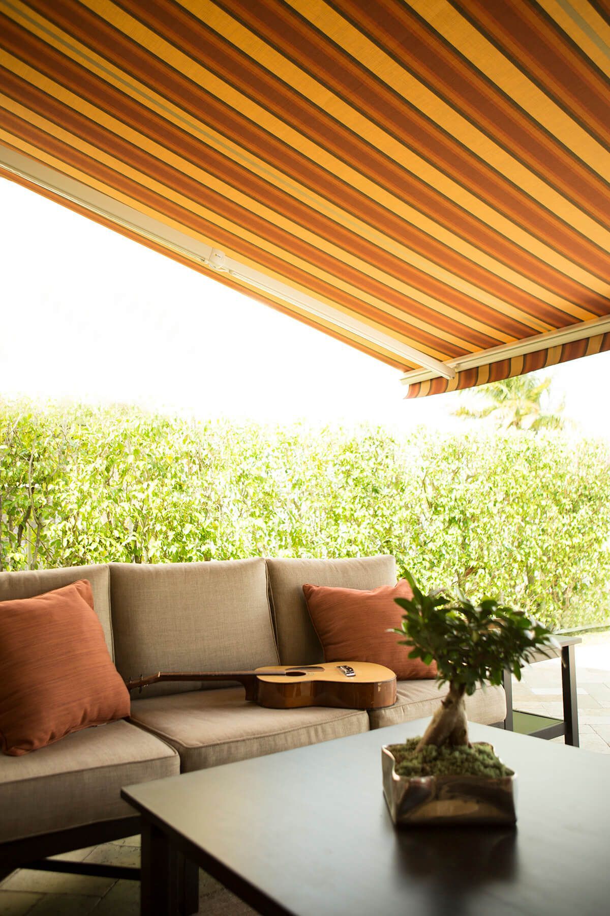 Outdoor patio with striped awning.