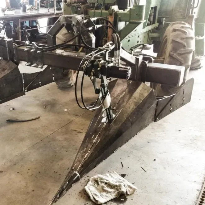Heavy-duty hydraulic farming or excavation attachment with sharp steel plow blade
