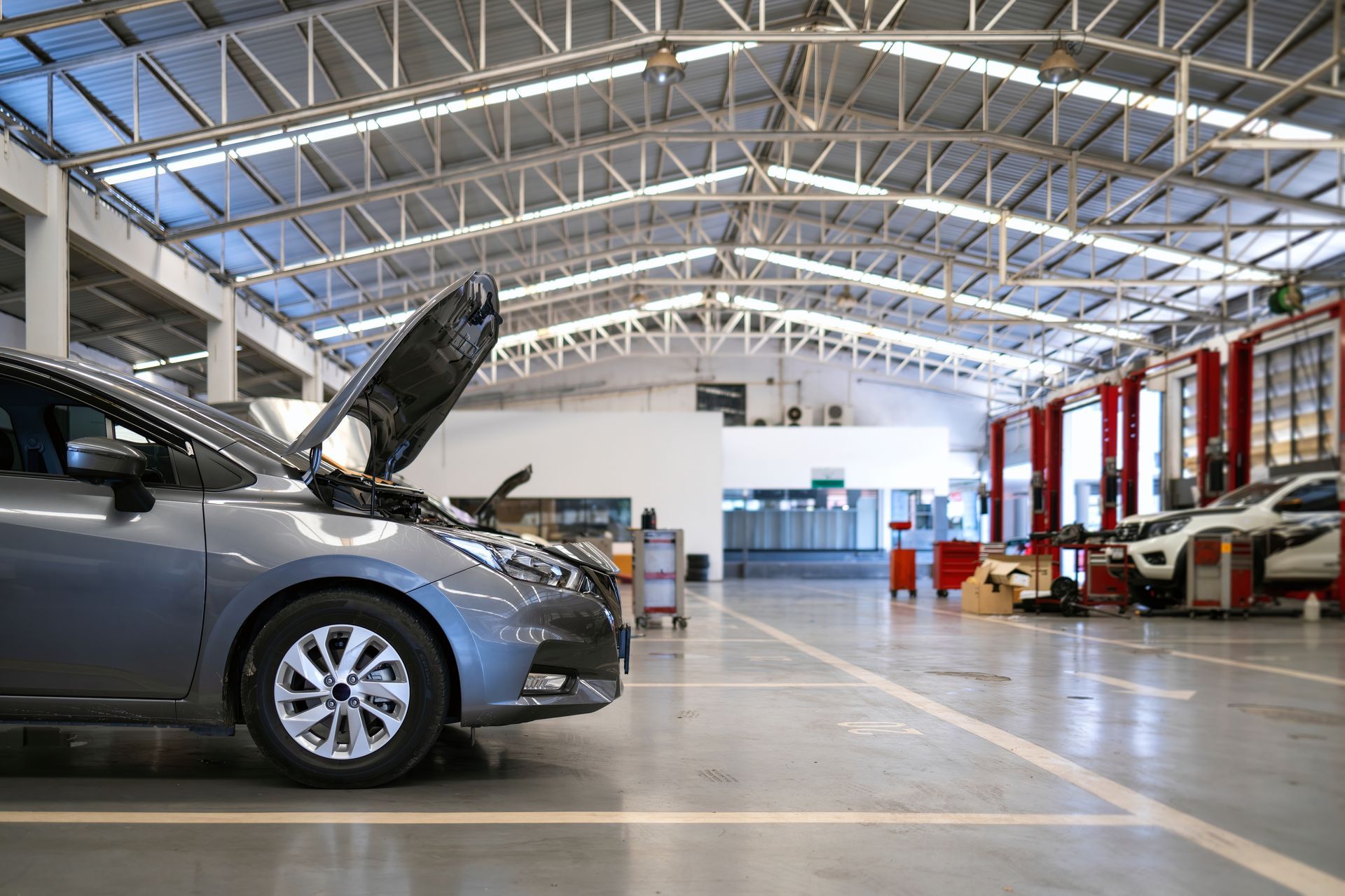 A car is parked in a garage with its hood up | Corb's Auto Repair LLC