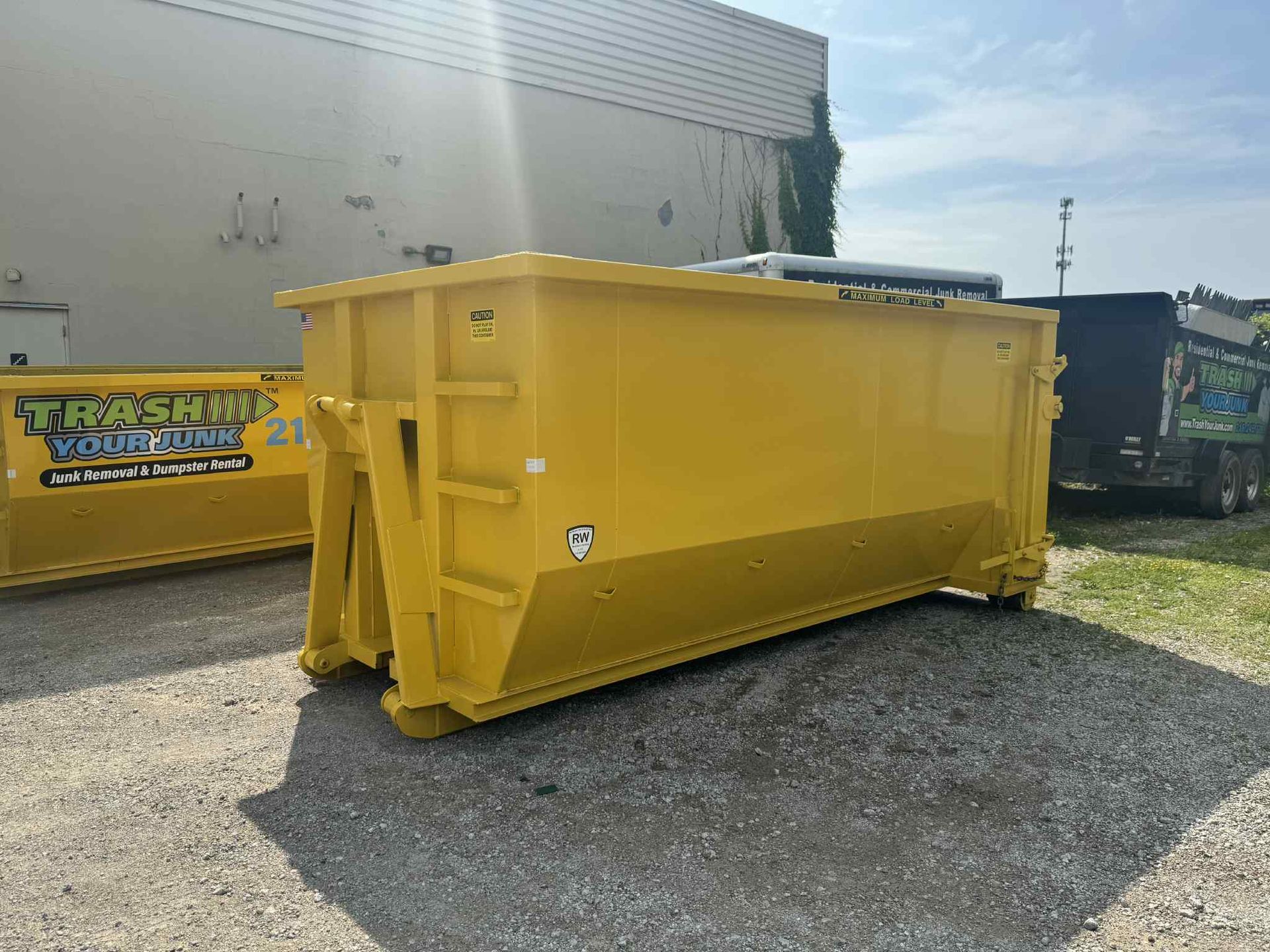 A large yellow dumpster with a turtles logo on it