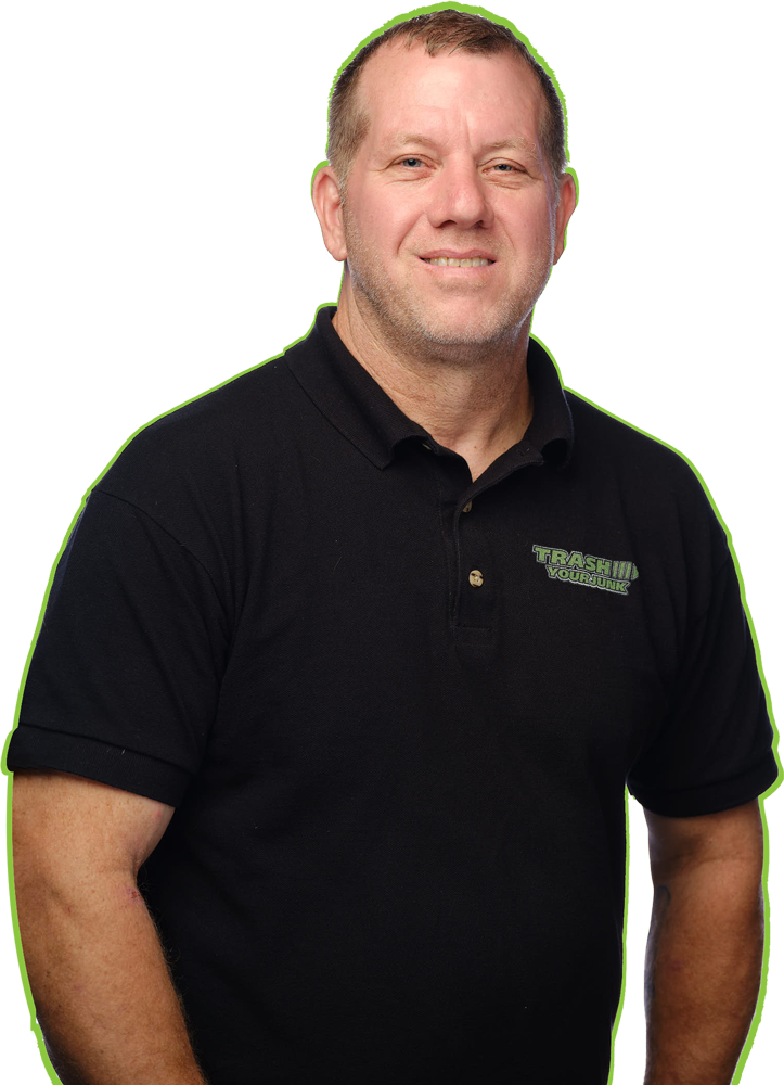 A man wearing a black shirt with a green border is smiling