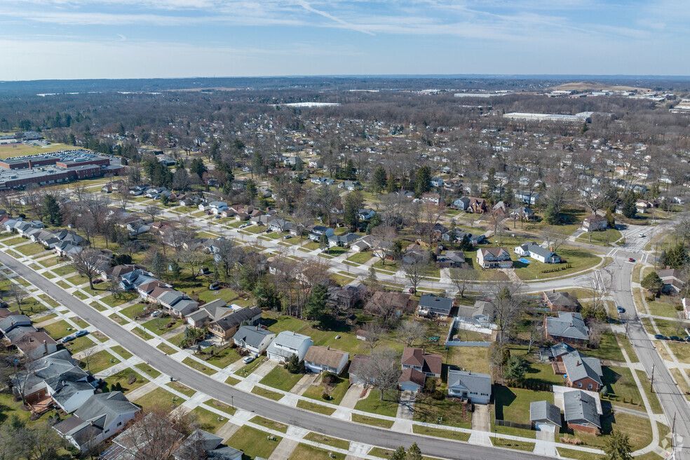 An aerial view of a residential area with lots of houses and trees.