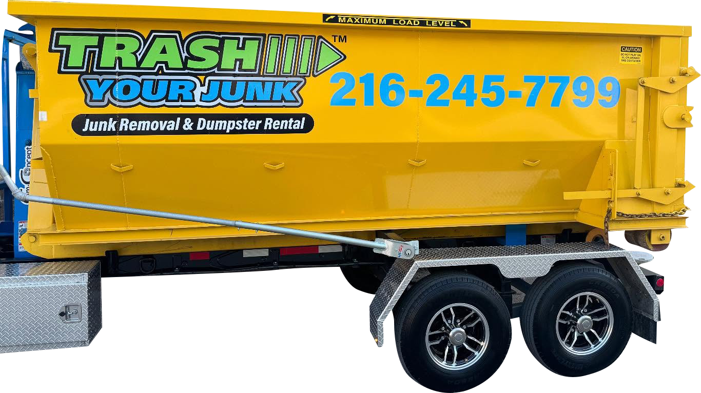 A trash truck and trailer are parked next to each other.