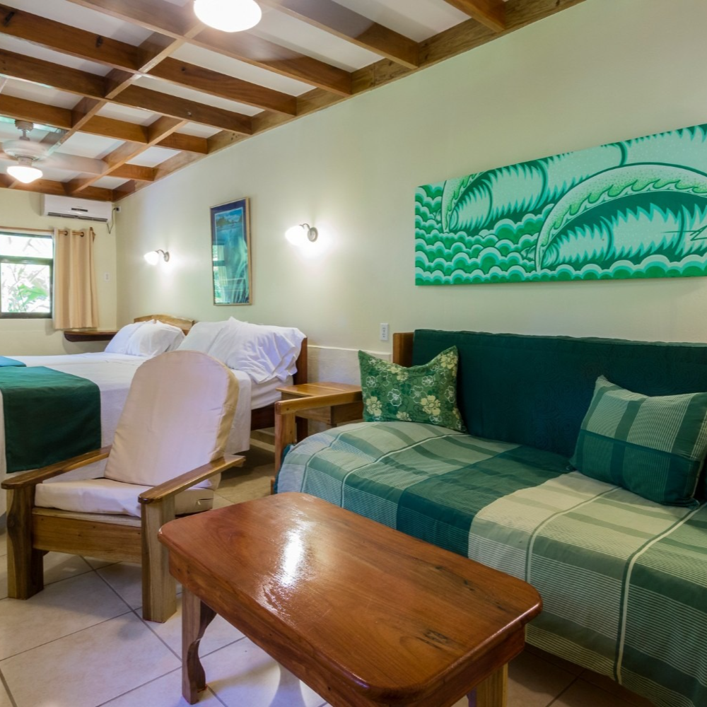 A hotel room with two beds and a couch