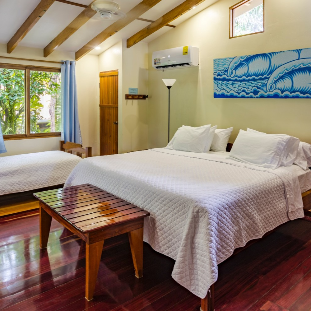 A bedroom with a king size bed and two twin beds