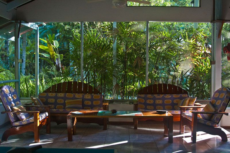 A living room with a couch , chairs , and a table.