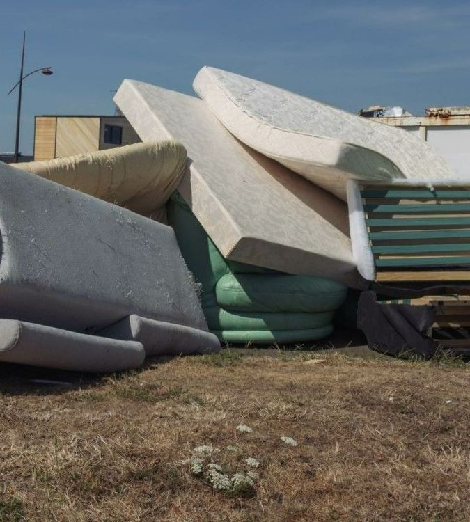 Mattress and couch at the dump