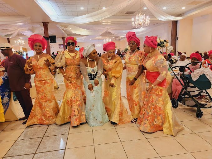 A group of women are standing next to each other in a room.