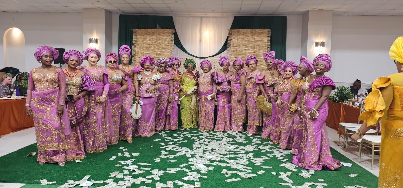 A group of women in purple dresses are posing for a picture.