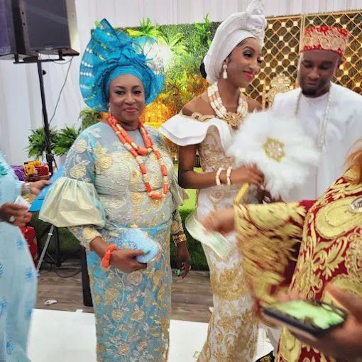 A group of people are standing next to each other in a room.