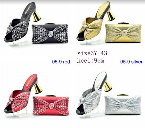 A pair of black shoes next to an orange purse