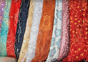 A pair of black shoes next to an orange purse