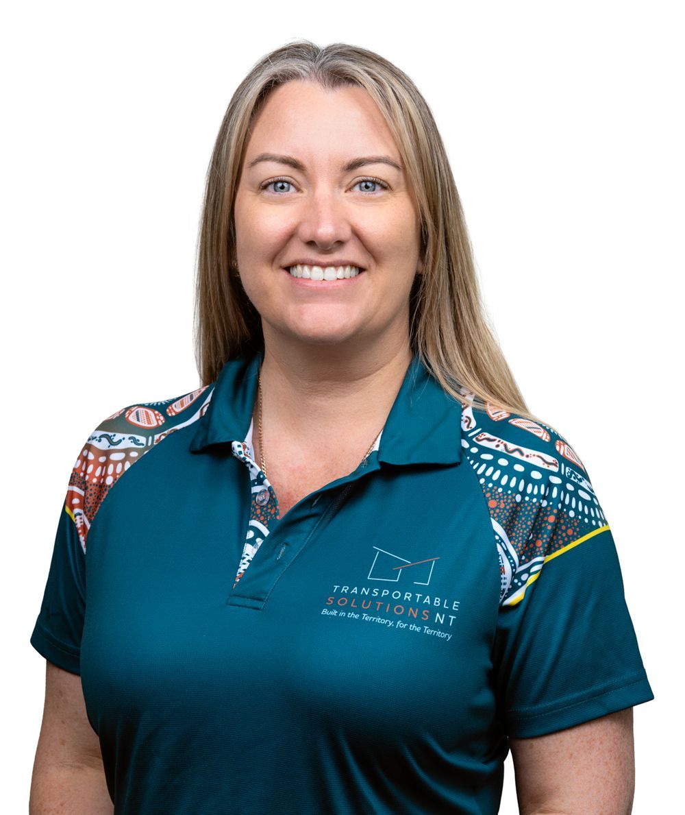 A woman is wearing a blue polo shirt and smiling.