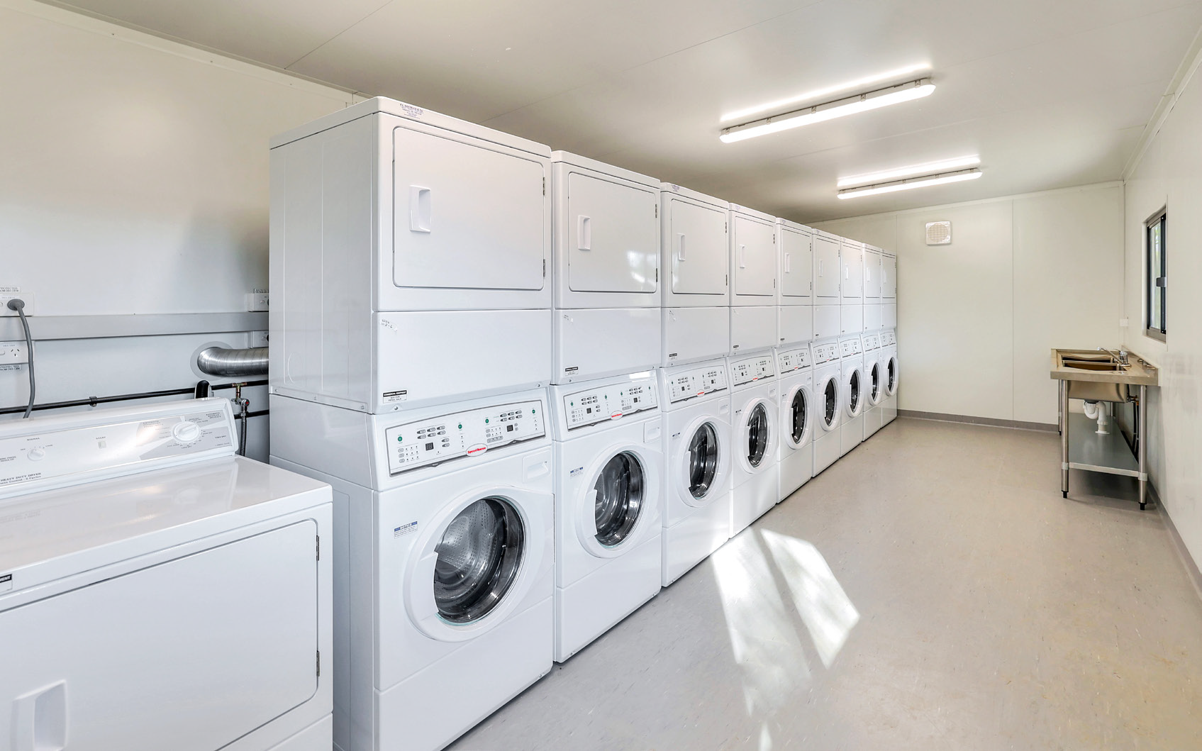 There are a lot of washers and dryers in this laundromat.