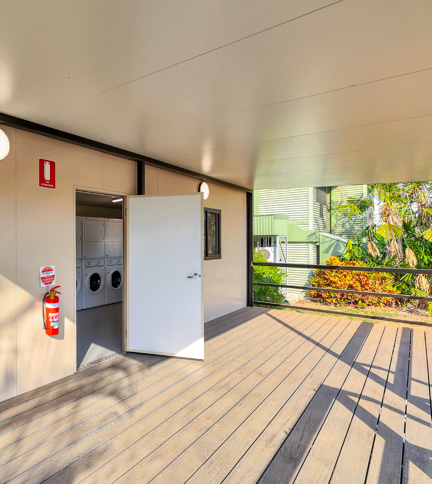A laundromat with a wooden deck and a fire extinguisher on the wall