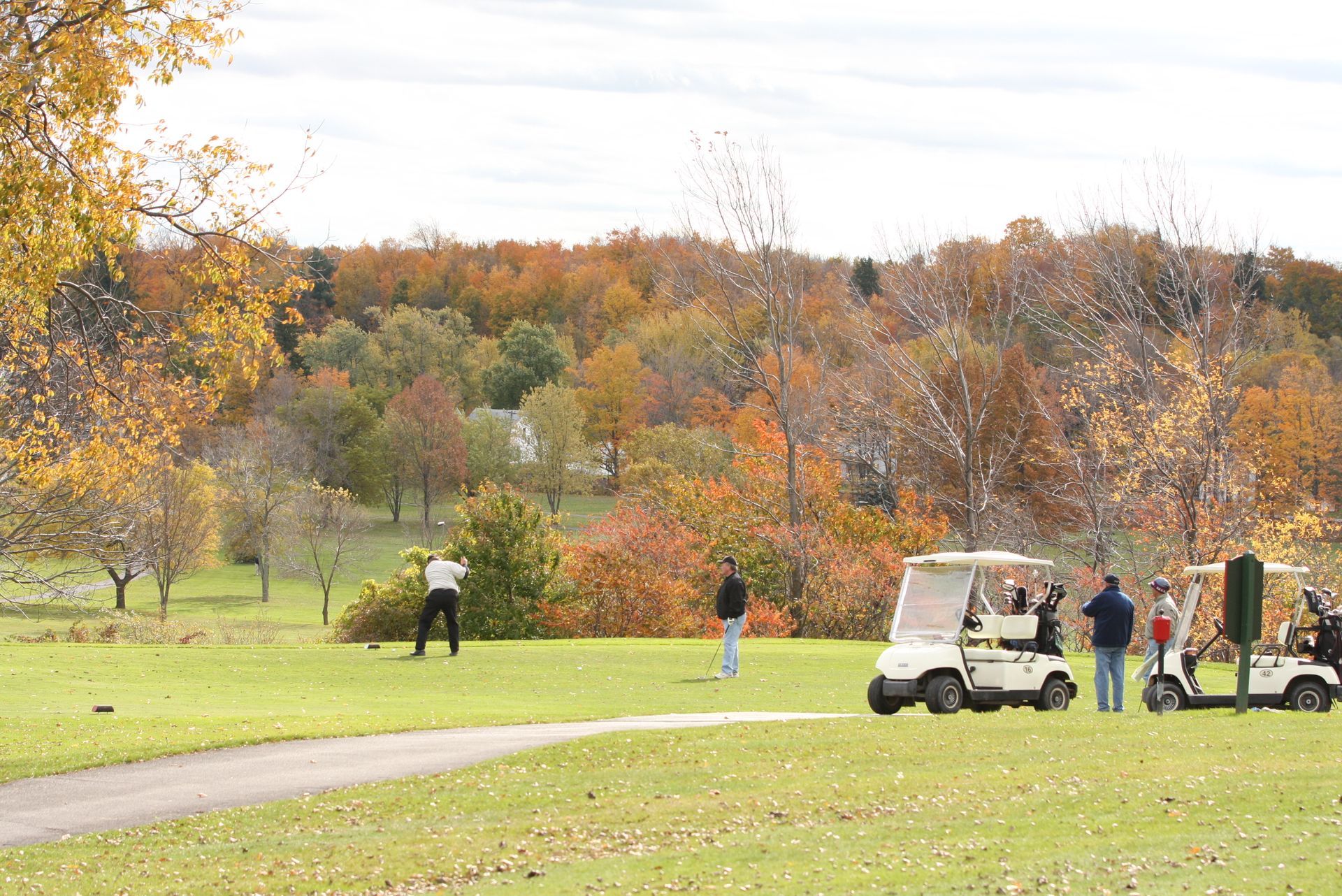 A group of people are playing golf on a golf course.