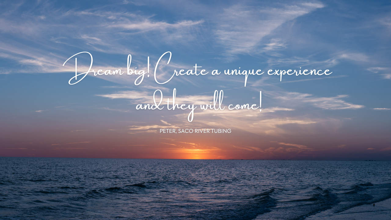 Sunset over the ocean with white text saying Dream Big