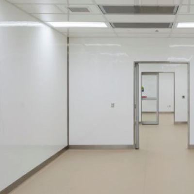 An empty room with white walls and a sliding glass door