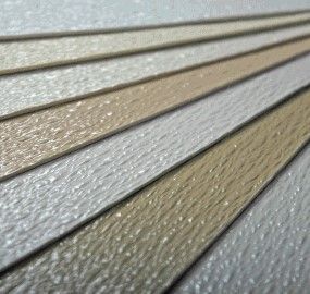 A close up of a stack of sheets of paper in different colors.