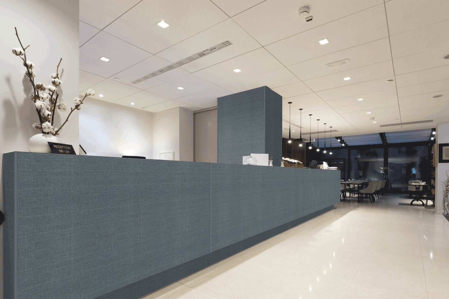 A hotel lobby with a long blue counter