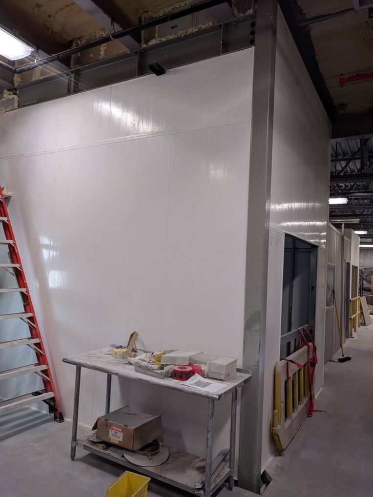 A room with a table and a ladder in it.