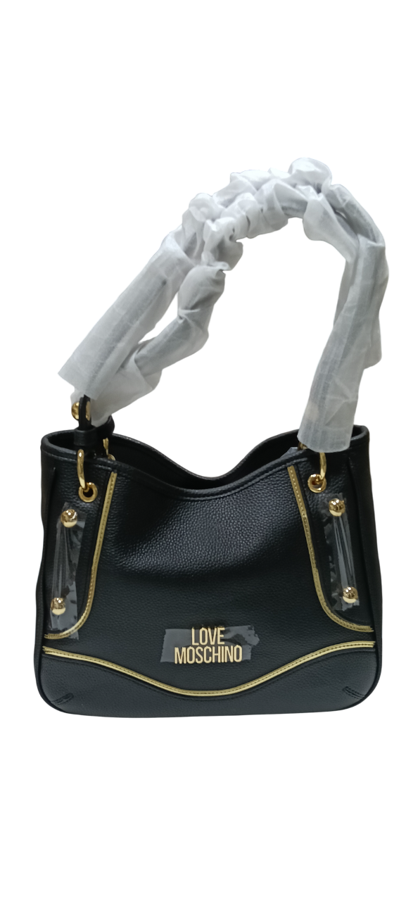 Bolso de mano negro con detalles dorados y asas envueltas en papel de seda blanco.