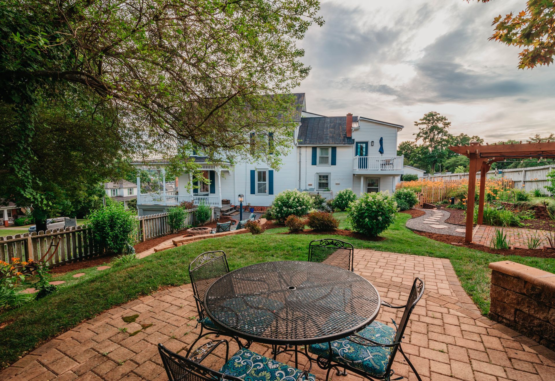 A patio with a table and chairs in front of a house.